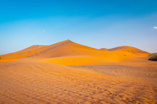 Sunset in desert tour in Merzouga, Morocco, Erg Chebbi dunes and path for camping in the Sahara to stay overnight in Berber desert camp