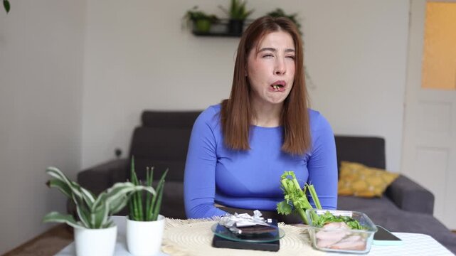 Young woman forces herself to eat healthy food despite hating the taste believing natural nutrition is better for long term health than relying on pills