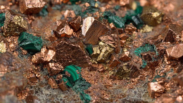 Extreme macro shot of native copper ore crystals mixed with green malachite mineral deposit