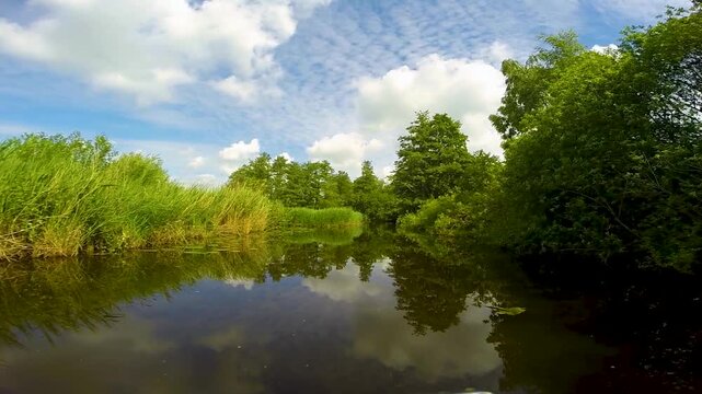 Point of view of a boat boat cruising through Dutch channels, Netherlands