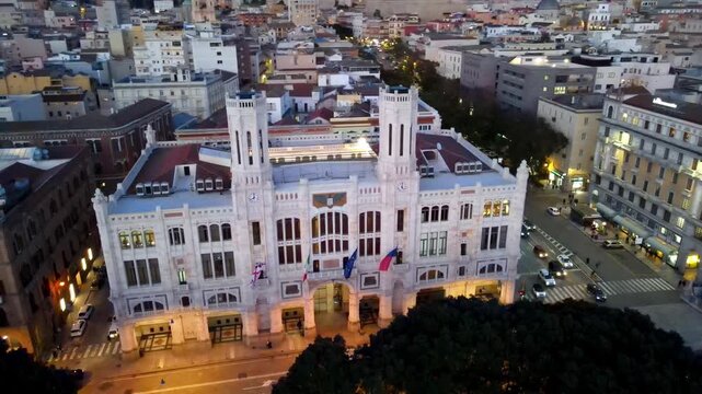 Scenic aerial orbit from palace to the beautiful harbor of Cagliari at dusk