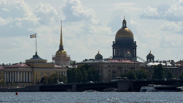Scenic view of the Admiralty building and St. Isaac's Cathedral across the Neva river on a sunny summer day in St. Petersburg.