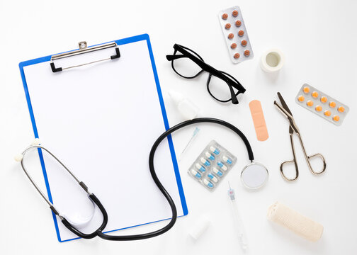 medical stethoscope and clipboard on white