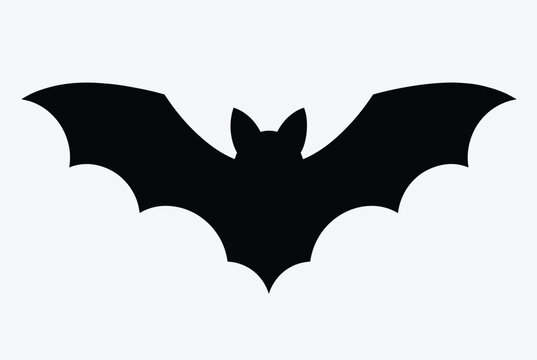 Black bat silhouette with spread wings isolated on a solid light gray background, perfect for halloween designs.