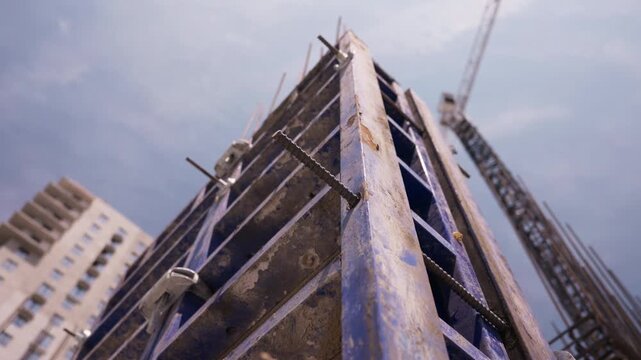Low angle view of concrete wall formwork at high rise construction site