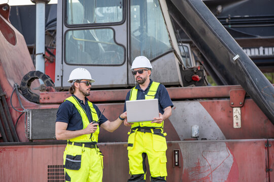 Field engineer beside an industrial service truck, supporting equipment inspection, maintenance and utility operations.