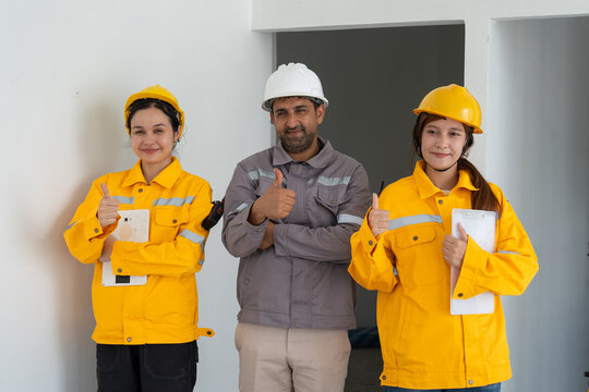 Construction team at a building site, promoting teamwork, safety and workplace diversity.