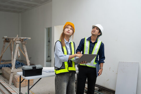 Construction inspector reviewing project plans with a colleague, highlighting teamwork, site inspection and quality assurance.