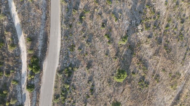 Top-Down Drone View of a Winding Rural Road Near Casertavecchia, Italy