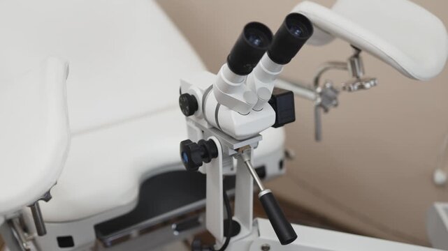 Professional colposcope in a gynecology examination room. Concept gynecological care, women's healthcare, medical equipment, reproductive health, clinical diagnostics.