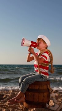 A happy child is having fun during summer vacation. The concept of dreams and travel. Vertical video. Slow motion