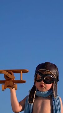 A happy child is having fun during summer vacation. The concept of dreams and travel. Vertical video. Slow motion