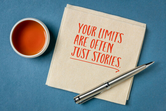 Your Limits Are Often Just Stories &ndash; inspirational handwritten note on a napkin with tea and pen, encouraging confidence, courage, resilience, and breaking mental barriers.
