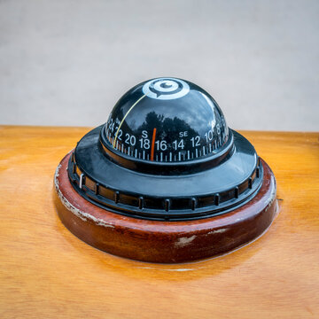 compass on a deck of wooden sea kayak