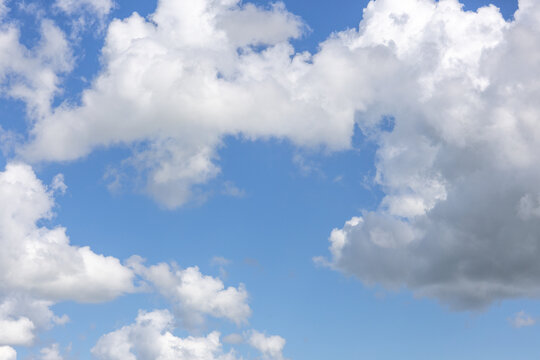 White clouds framing blue sky with copy space during daytime