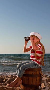 A happy child is having fun during summer vacation. The concept of dreams and travel. Vertical video. Slow motion