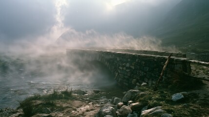 Obraz premium Weathered stone footbridge in swirling highland mist at golden overcast light