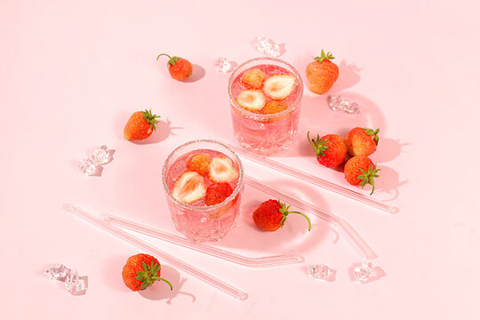 Refreshing summer lemonade cocktail, a mojito with strawberries, and iced soda, perfect summer party concept,bright, sunny summer banner serves as a menu promotion for a caf or bar.Modern still life