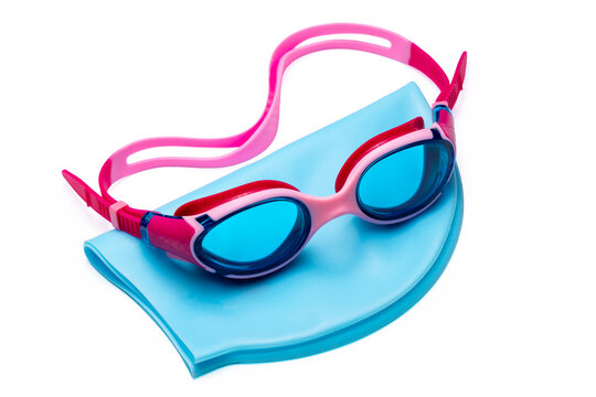 Pink and blue swimming goggles with a light blue swim cap isolated on white background