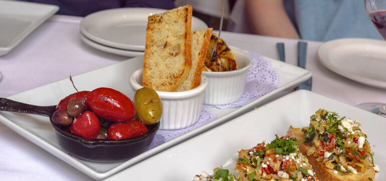 Marinated olives in cast iron skillet with toasted bread