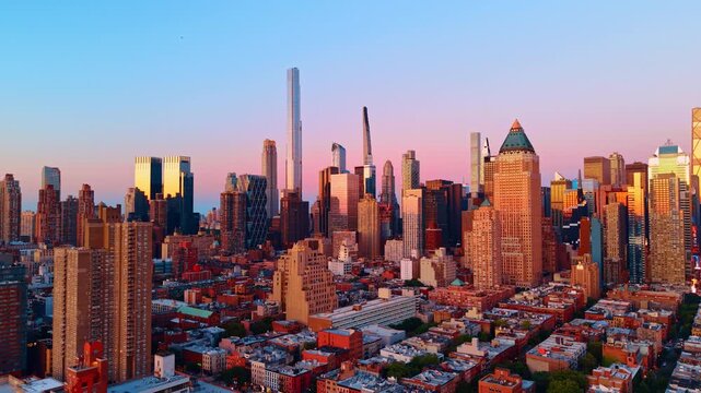 Red-brick buildings of New York colored by the light of setting sun. Diverse architecture of metropolis from drone.
