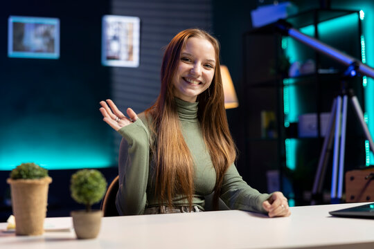Young female influencer filming a vlog indoors using modern equipment, content creator sharing lifestyle moments, engaging followers through social media live.