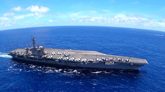 an aircraft carrier belonging to the American Navy is sailing on the high seas
