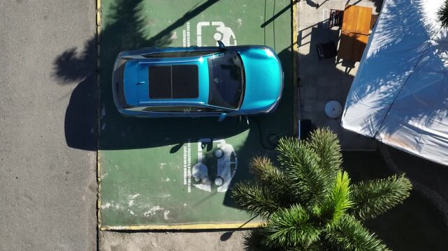 Electric Car Charging. The sustainable future of mobility powered by clean, sustainable energy that causes no harm to the planet. Aerial view.