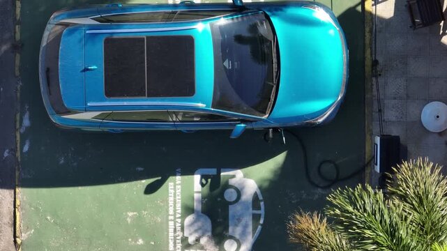 Electric Car Charging. The sustainable future of mobility powered by clean, sustainable energy that causes no harm to the planet. Aerial view.
