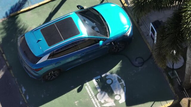 Electric Car Charging. The sustainable future of mobility powered by clean, sustainable energy that causes no harm to the planet. Aerial view.