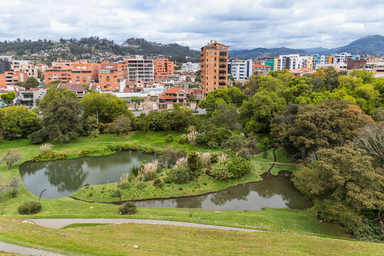 Cuenca's picturesque cityscape features modern residential buildings and high-rises, as well as the park and lagoon. Ecuador, South America