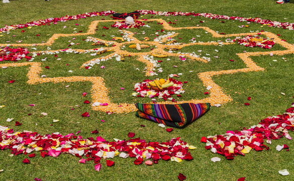 The Chakana, or Andean Cross, created with flowers and grains. It is a spiritual ritual commonly performed in Ecuador during ceremonies like Inti Raymi to honor Pachamama (Mother Earth). Perfomed in  