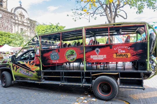 Tequila, Mexico - March 29 2026: Vibrant open-air tour bus in Tequila, Mexico, ready for a Don Tomas Distillery adventure. Exploring the historic town center and tequila culture in Jalisco.