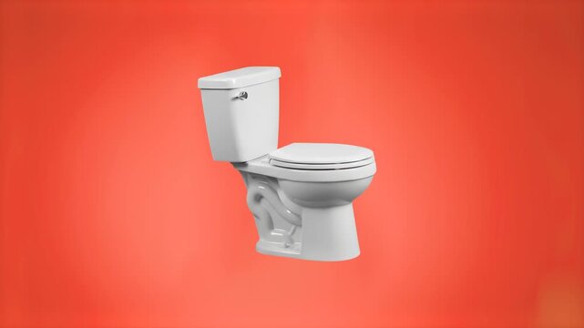 A clean white ceramic toilet bowl with flush tank standing against a vibrant coral red studio backdrop. Designed for commercial plumbing marketing, bathroom product branding, sanitary appliance promos