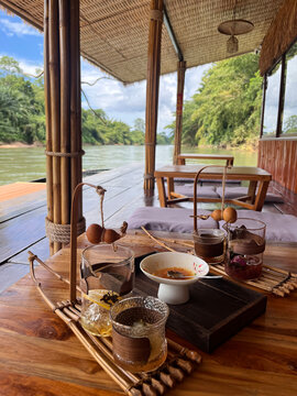 Charming riverside terrace of Hua Cha Tea House decorated in traditional Chinese style, Kanchanaburi, Thailand.