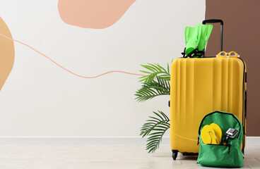 Yellow suitcase with green flippers and backpack, summer travel and vacation preparation, holiday adventure © Pixel-Shot