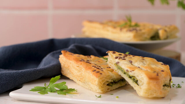 Flaky puff pastry stuffed with spinach and garnished with flax seeds