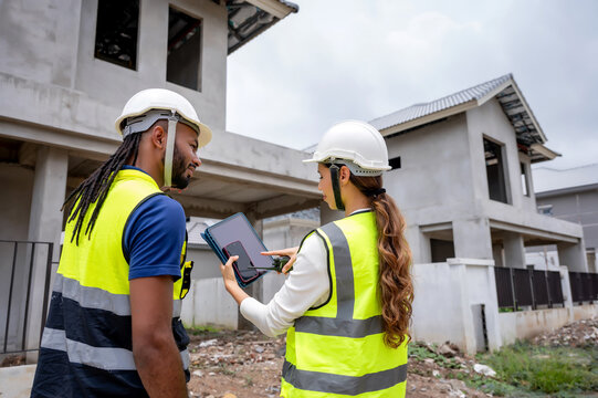 Civil construction managers inspecting unfinished residential building project with civil engineer, checking defect list in tablet, Concept of property inspection scene for housing development.