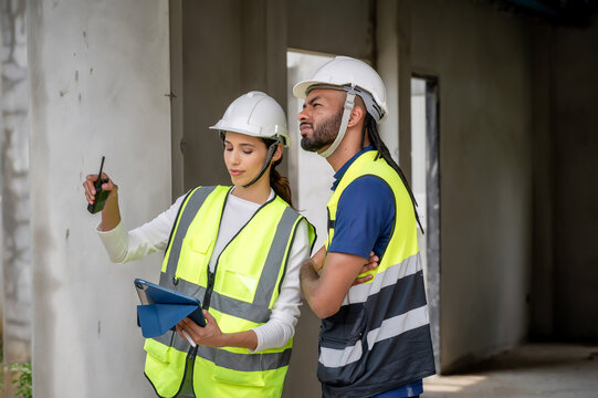 Civil construction managers inspecting unfinished residential building project with civil engineer, checking defect list in tablet, Concept of property inspection scene for housing development.