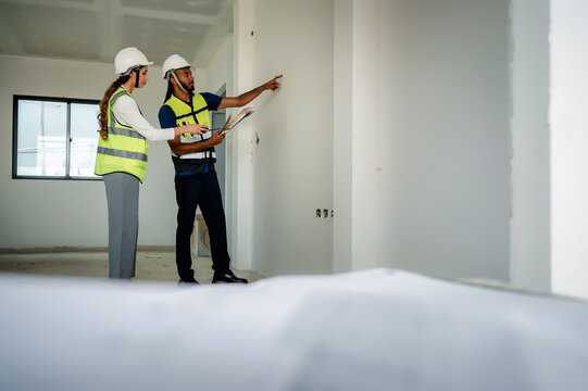 Construction manager consulting home interior design palette layout with builder engineer, selecting paint tones for residential house and finishing, concept of real estate investment development.