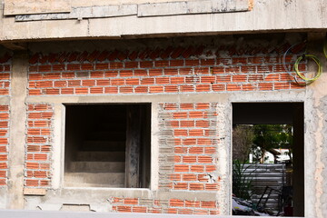 Obraz premium exterior view of brick house under construction with concrete structure