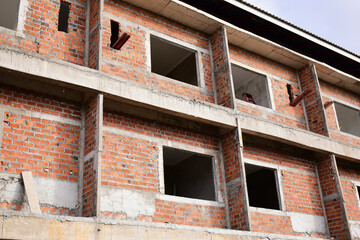 Obraz premium exterior view of brick house under construction with concrete structure