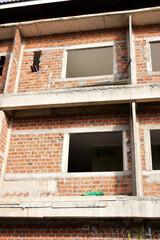 Obraz premium exterior view of brick house under construction with concrete structure