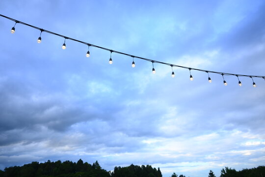decorative string light hanging outdoors under a clear daylight sky
