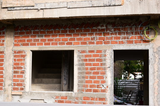 exterior view of brick house under construction with concrete structure
