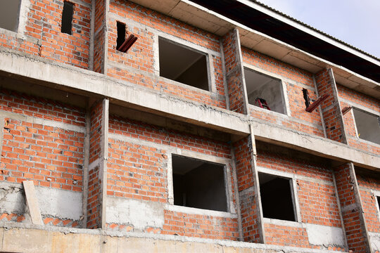 exterior view of brick house under construction with concrete structure