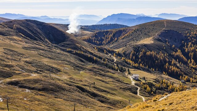 Rising smoke in autumnal landscape, skiing and hiking area Merano 2000, near Merano, South Tyrol, Italy