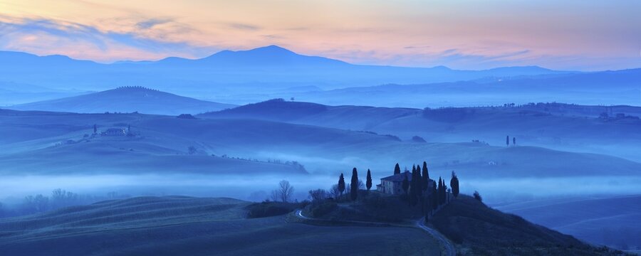 Morning atmosphere in Tuscany, hilly landscape with fog at dawn, Country house Belvedere, Val d'Orcia, Tuscany, Italy