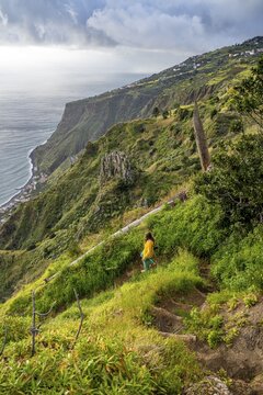 Hiker on footpath, Miradouro da Raposeira, cliffs, coast and sea, Paul do Mar, Madeira, Portugal