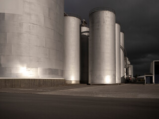 Car background, automotive backplate, industrial storage silos for oil, fuel, grain. © Chris